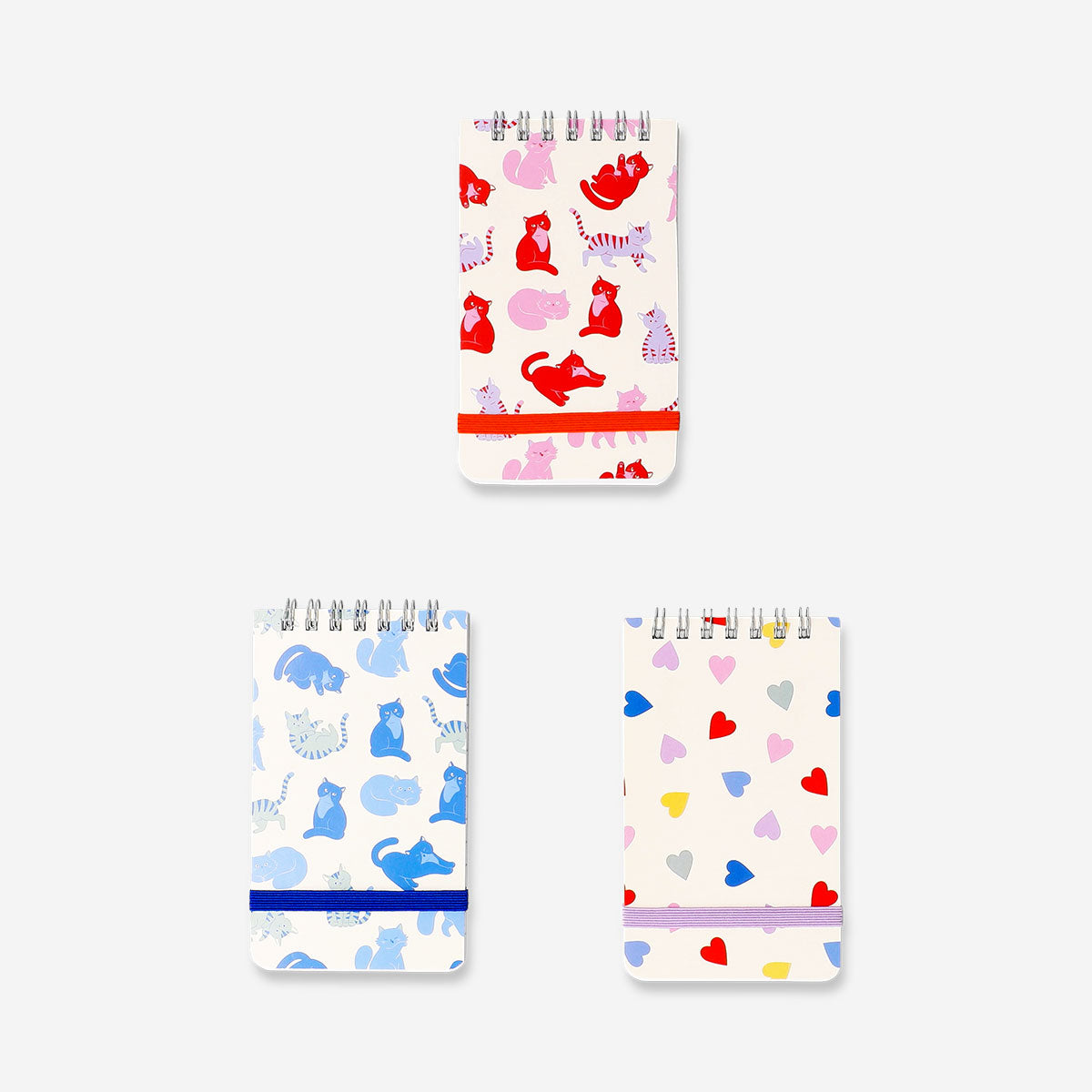 Set of three spiralbound office notepads with playful cat print by Flying Tiger Copenhagen, ideal for note-taking and organization.