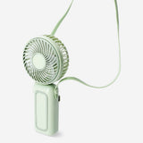 Green handheld fan with strap by Flying Tiger Copenhagen, compact gadget ideal for cooling on the go.