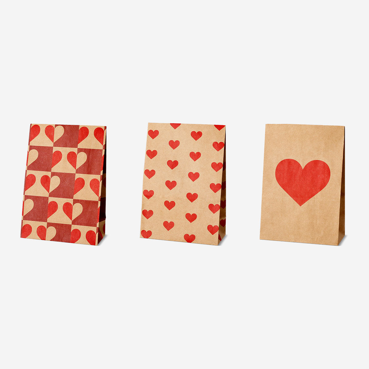 Set of three Flying Tiger Copenhagen paper gift bags with heart print, ideal for office gift packaging or special occasions.