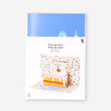 Flying Tiger Copenhagen birthday card featuring a colorful 3D pop-up cake slice design for office celebrations.