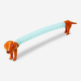 Colorful telescopic sausage dog toy from Flying Tiger Copenhagen, extended and coiled for playful display.