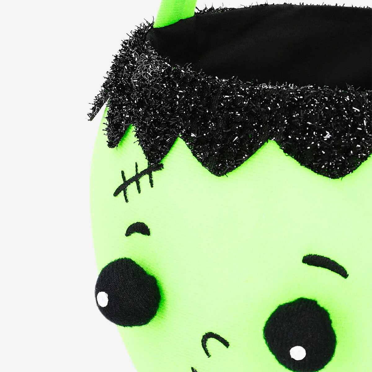 Green zombie trick or treat bucket for Halloween party, featuring spooky zombie design by Flying Tiger Copenhagen