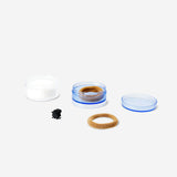 Three stackable personal care jars from Flying Tiger Copenhagen, featuring clear plastic containers with white lids for organization.