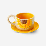 Flying Tiger Copenhagen 160 ml mug with embossed sunflower design and matching saucer for kitchen use.