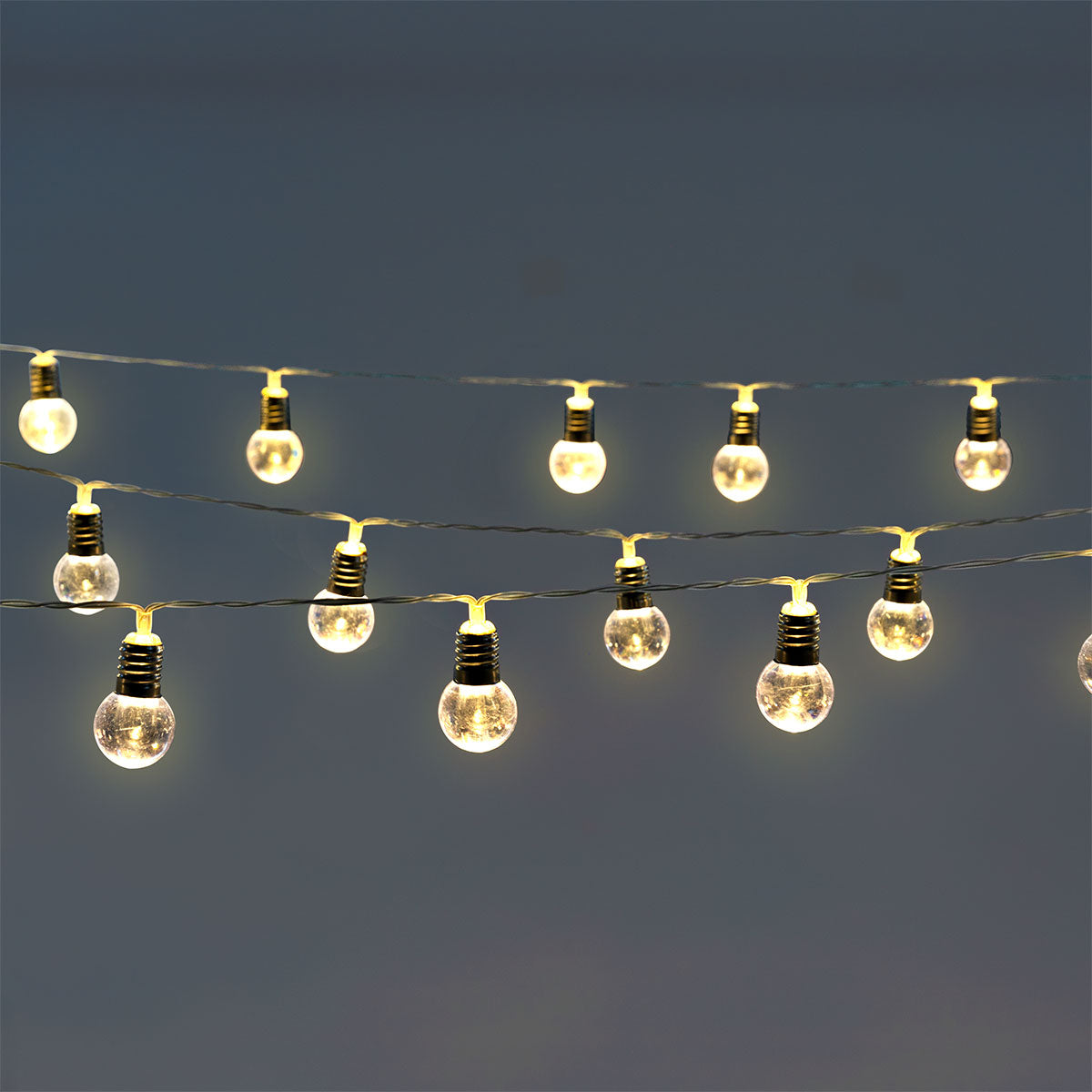 String lights with clear bulbs by Flying Tiger Copenhagen, perfect for home decor, featuring a string of illuminated glass bulbs.