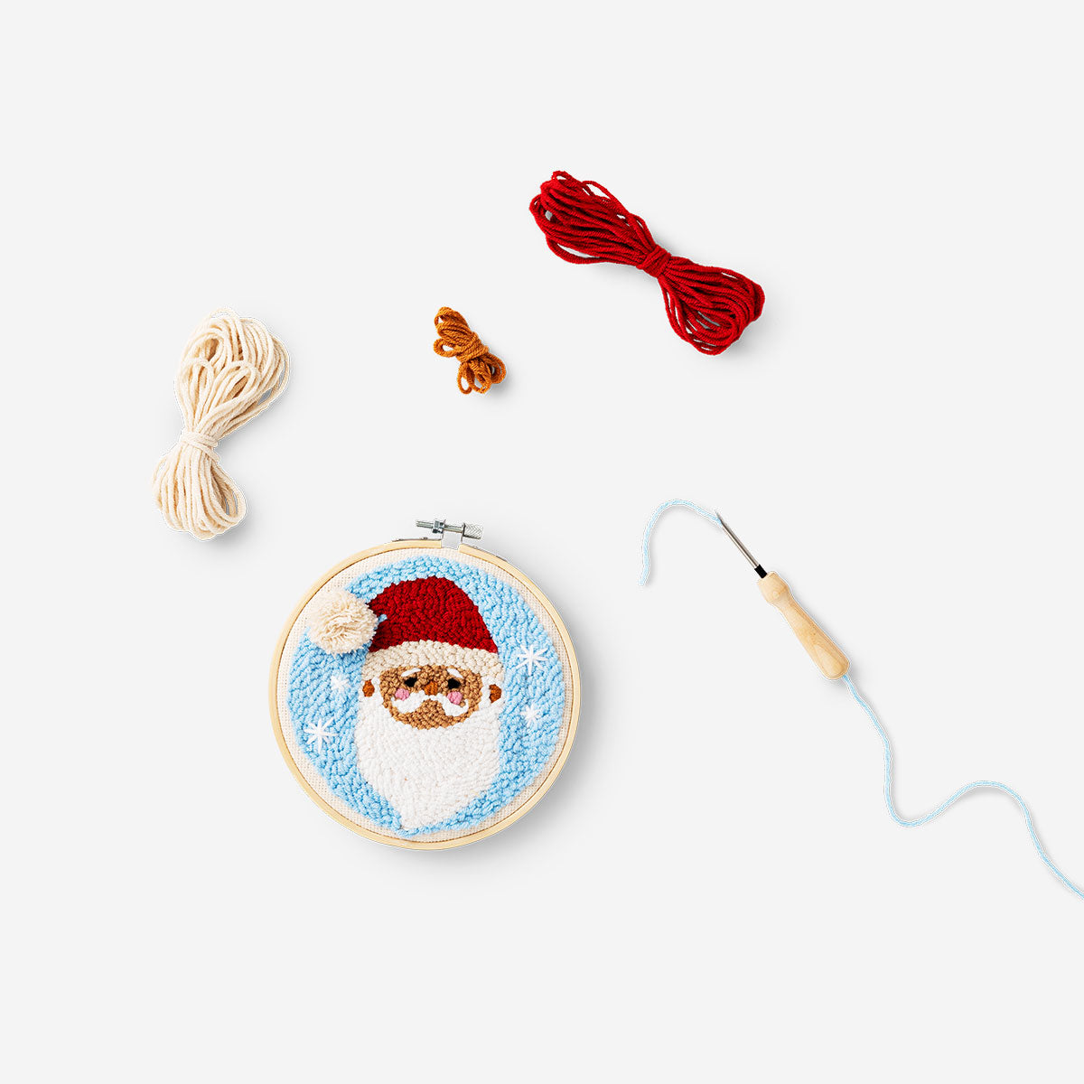 Punch needle Santa set by Flying Tiger Copenhagen, featuring colorful tools and materials for holiday embroidery crafts.
