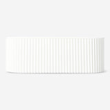 White cable tidy unit for home organization by Flying Tiger Copenhagen, neatly wrapped cords to reduce clutter.