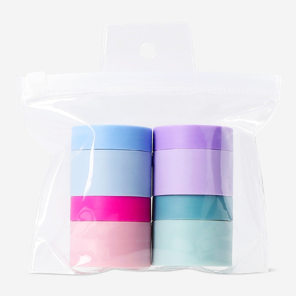 Set of four Flying Tiger Copenhagen travel jars with colorful stickers for toiletries and cosmetics storage.