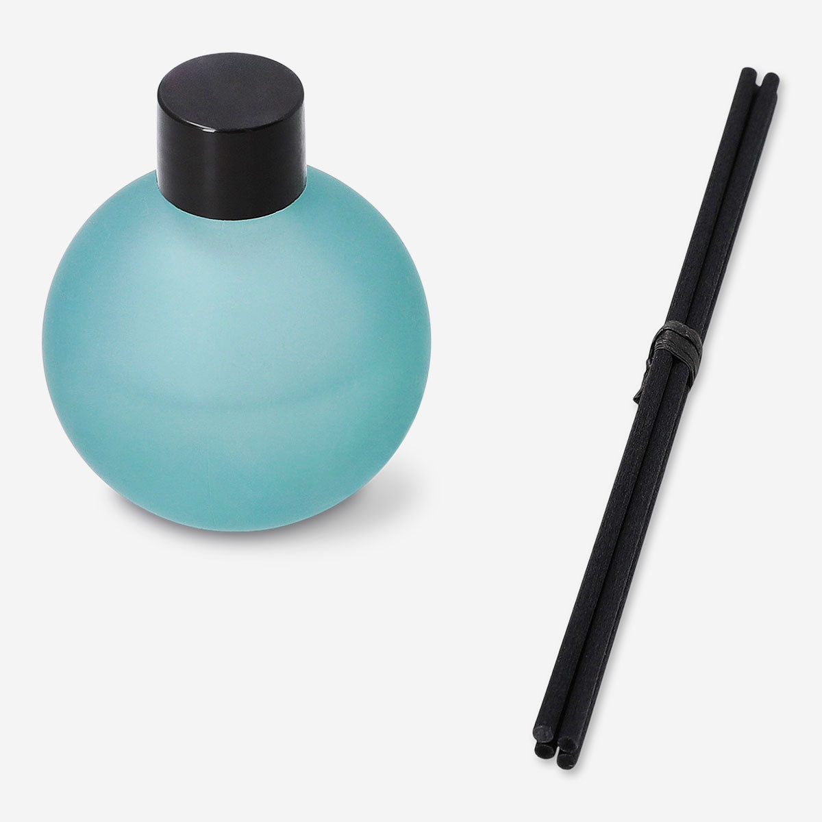 Flying Tiger Copenhagen reed diffuser with cardamom and chestnut scent in a glass bottle, creating a cozy home fragrance.