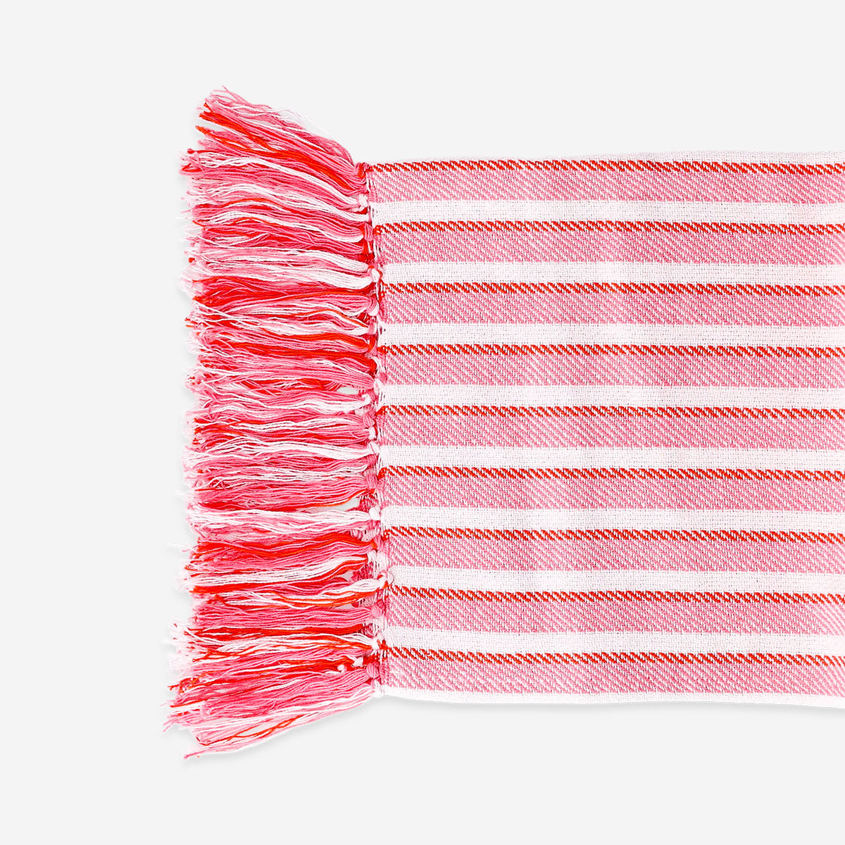 Pink striped throw blanket with fringes, 120x170 cm, from Flying Tiger Copenhagen, displayed on a cozy home setting.