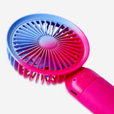 Gradient pink handheld fan with strap, Flying Tiger Copenhagen gadget, compact and portable for cooling on the go.
