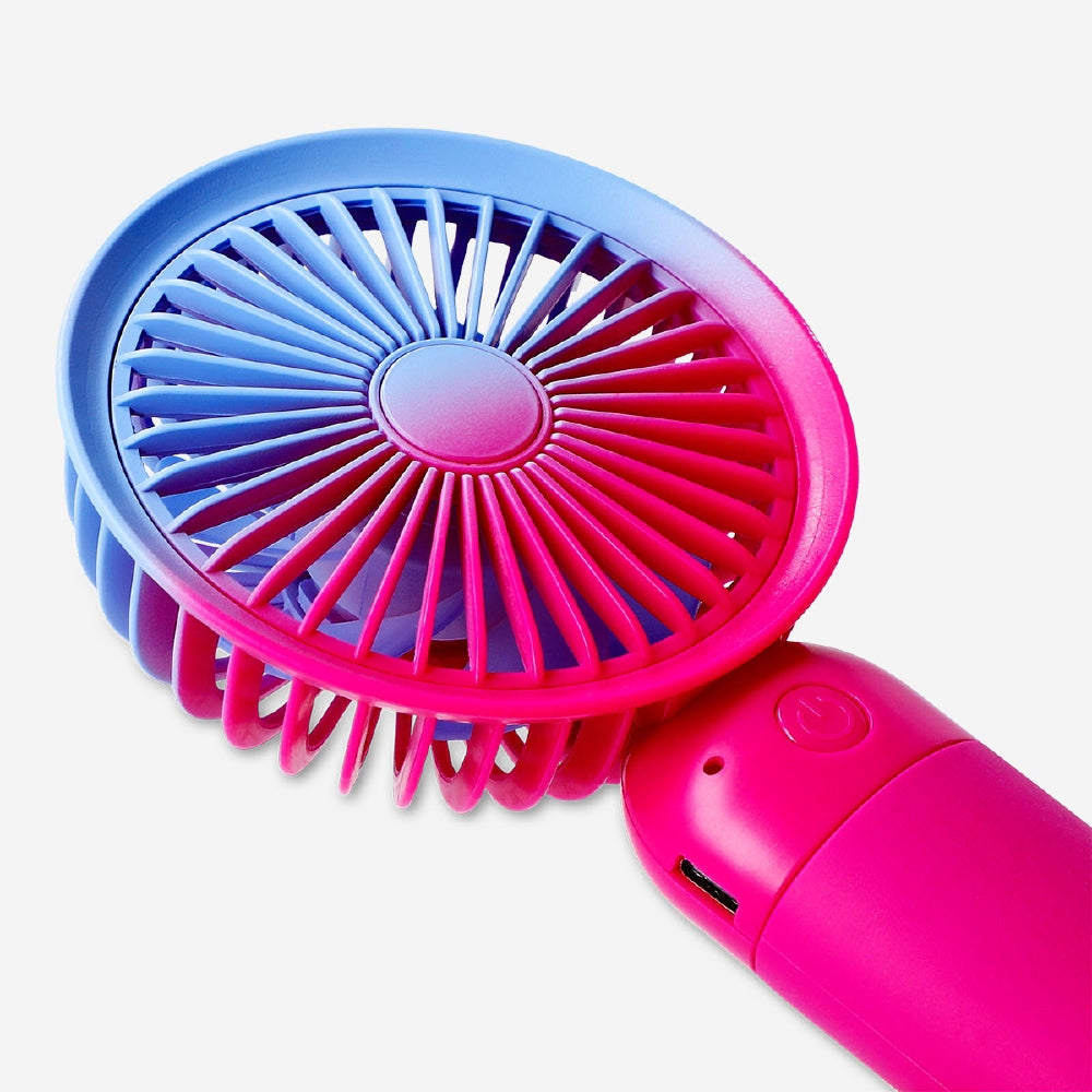 Gradient pink handheld fan with strap, Flying Tiger Copenhagen gadget, compact and portable for cooling on the go.