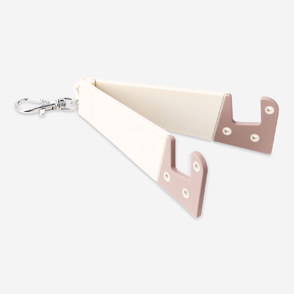 Flying Tiger Copenhagen media phone stand with attached key ring, compact and portable for hands-free use and key organization.