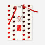 Two foil hearts gift bags in vibrant colors from Flying Tiger Copenhagen, ideal for office gift wrapping.