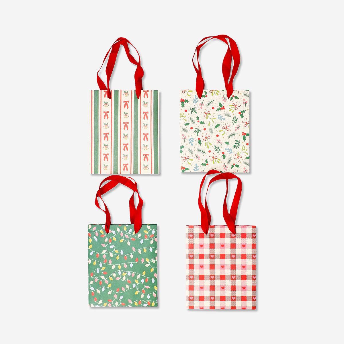 Four Christmas pattern gift bags for office use by Flying Tiger Copenhagen, featuring festive holiday designs.