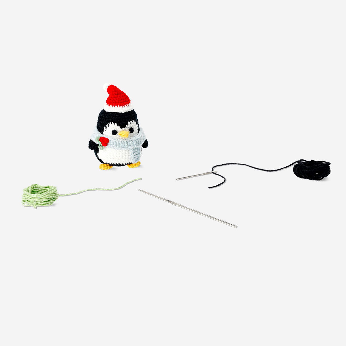 Colorful DIY crochet penguin hobby kit by Flying Tiger Copenhagen, showing the finished crocheted penguin figure.