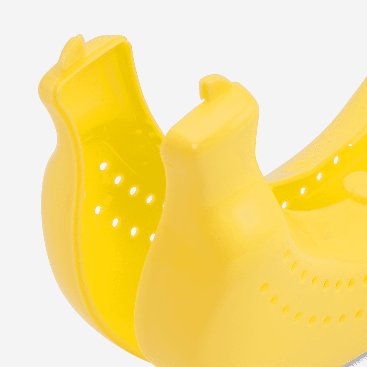 Flying Tiger Copenhagen banana-shaped kitchen case in bright yellow with a secure lid for storing bananas.