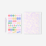 Flying Tiger Copenhagen floral office notebook with matching ballpoint pen and decorative stickers on a white background.