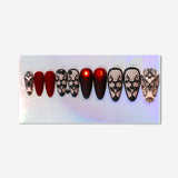 Matte black gothic press-on nails with intricate design, created by Flying Tiger Copenhagen for personal care.