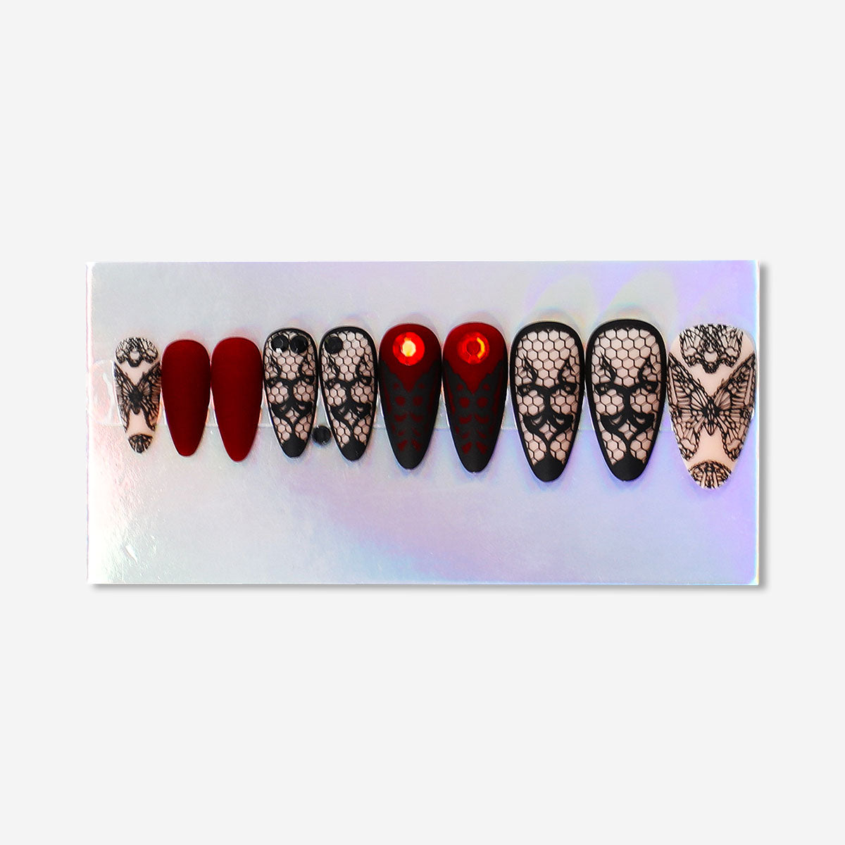 Matte black gothic press-on nails with intricate design, created by Flying Tiger Copenhagen for personal care.