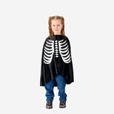 Kids Skeleton costume cape for parties by Flying Tiger Copenhagen, black with skeletal designs, perfect for Halloween or dress-up.