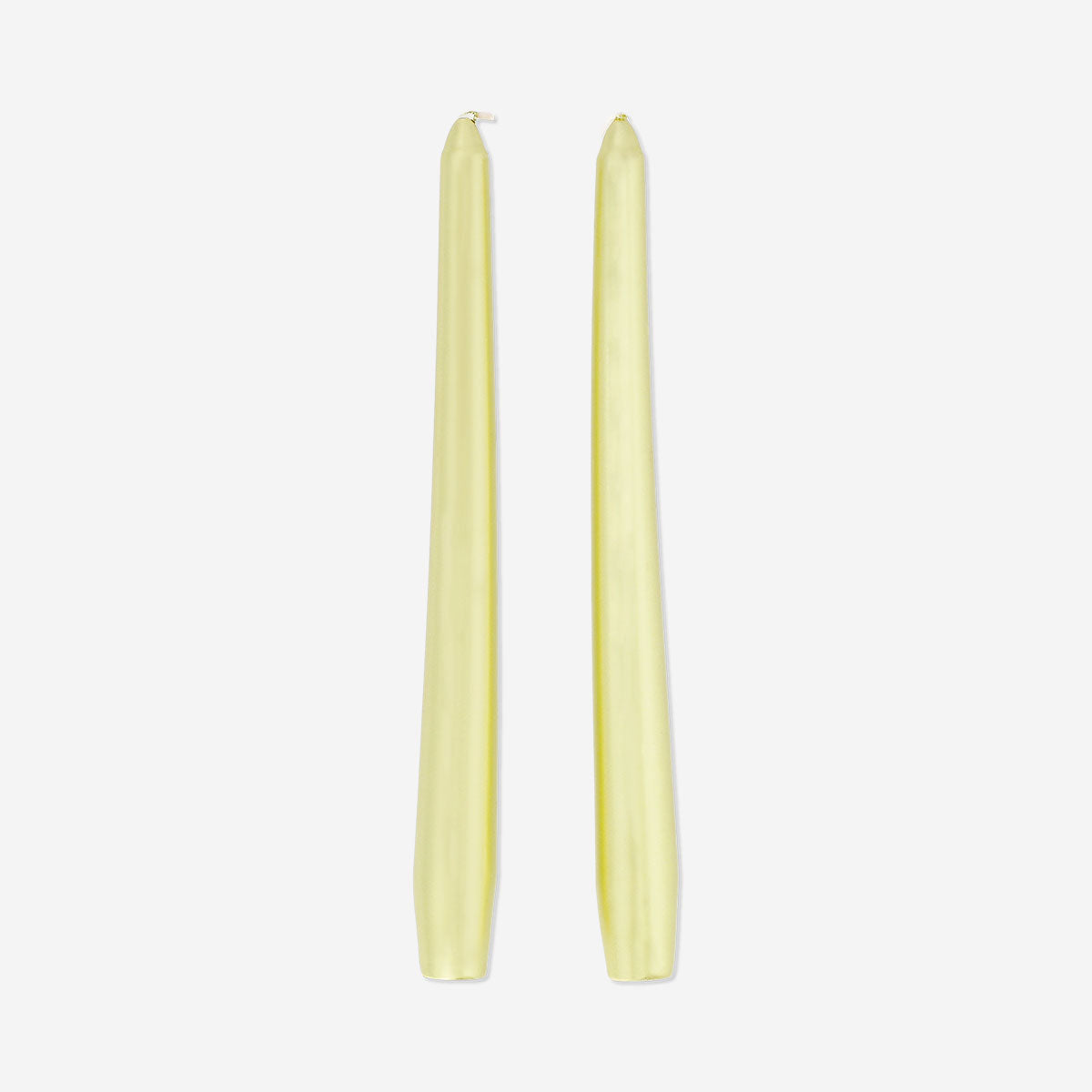 Two gold dinner candles from Flying Tiger Copenhagen, elegant home decor candles with a shiny metallic finish.