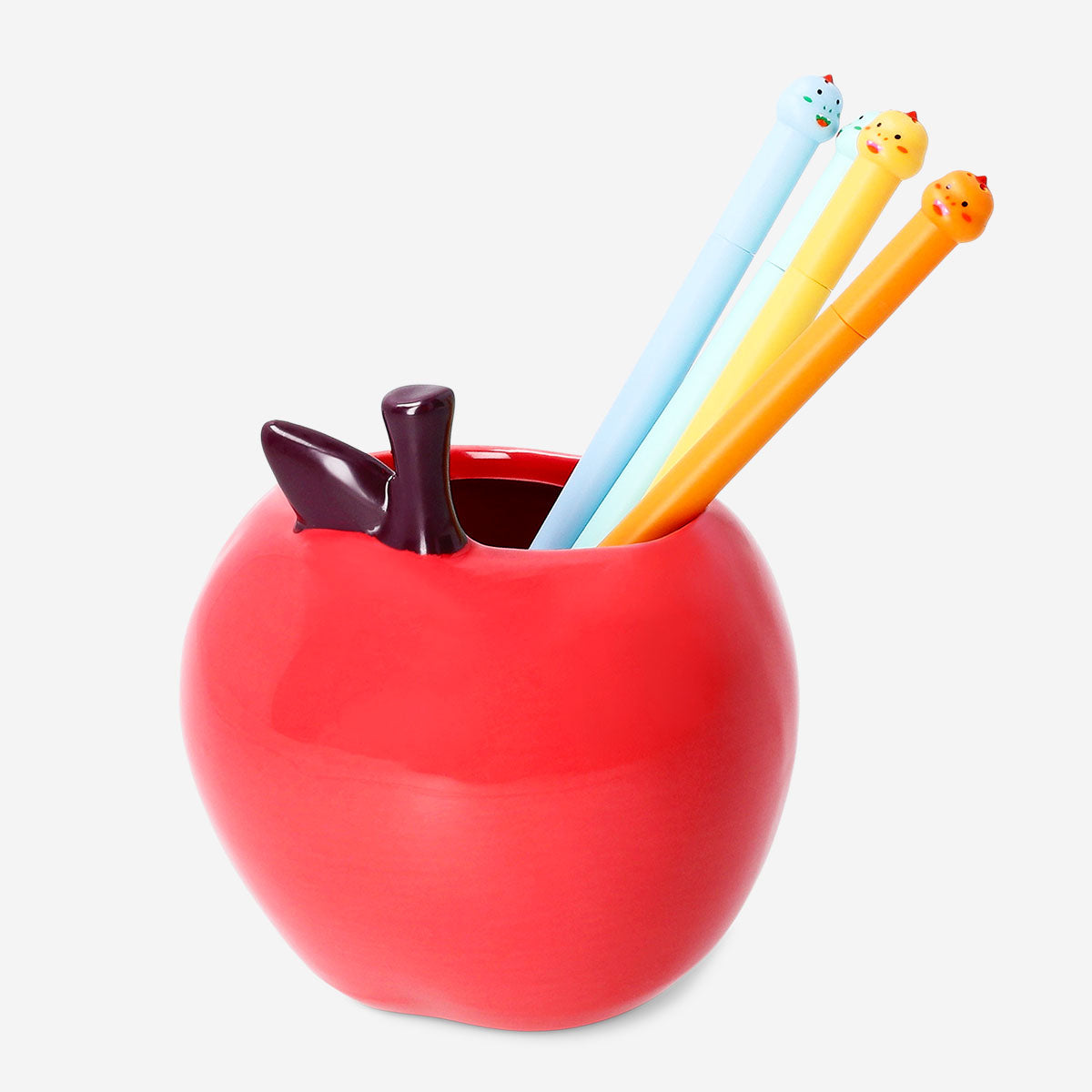 Red ceramic apple-shaped pencil holder from Flying Tiger Copenhagen for office desk organization.