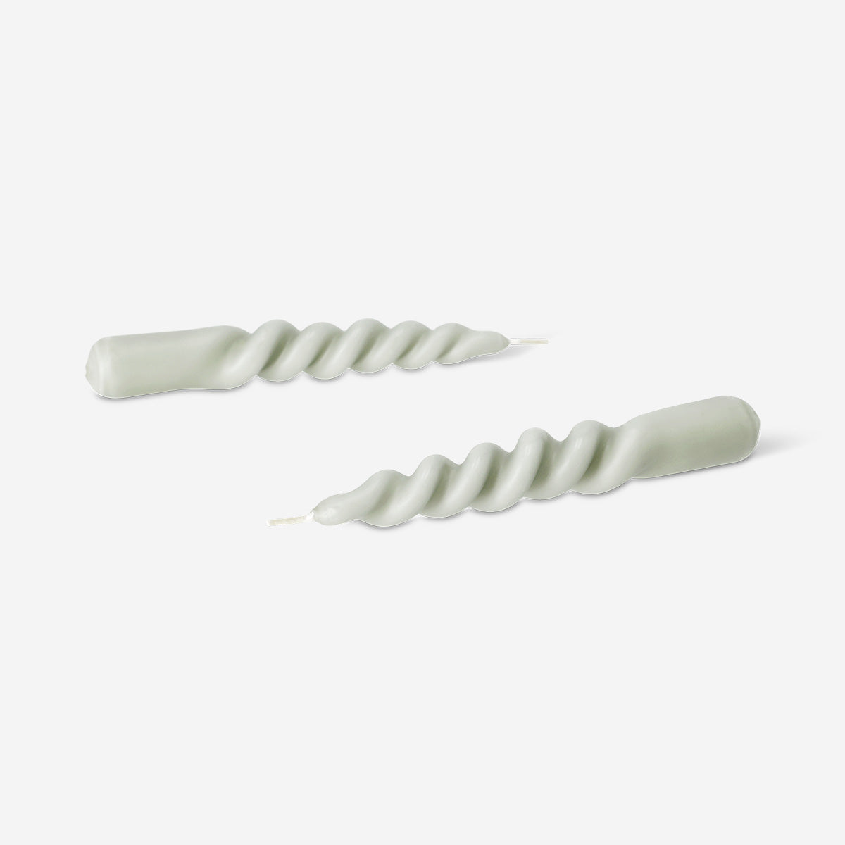 Two beige twisted dinner candles for home decor, featuring a stylish design from Flying Tiger Copenhagen.