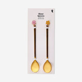 Two gold dessert spoons with floral decorations from Flying Tiger Copenhagen, featuring intricate flower details on each spoon.