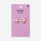 Textile stud earrings featuring seastars with pearls, designed by Flying Tiger Copenhagen, shown in a close-up image.