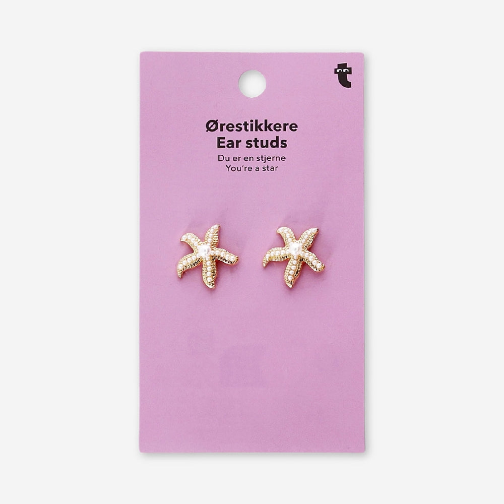 Textile stud earrings featuring seastars with pearls, designed by Flying Tiger Copenhagen, shown in a close-up image.