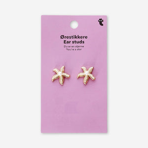 Textile stud earrings featuring seastars with pearls, designed by Flying Tiger Copenhagen, displayed on a neutral background.