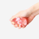 Pink hard candy fidget cube by Flying Tiger Copenhagen, featuring multiple tactile surfaces and small gadgets for stress relief.
