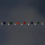 Colorful string lights with multi-colored pompoms, ideal for home decor by Flying Tiger Copenhagen.