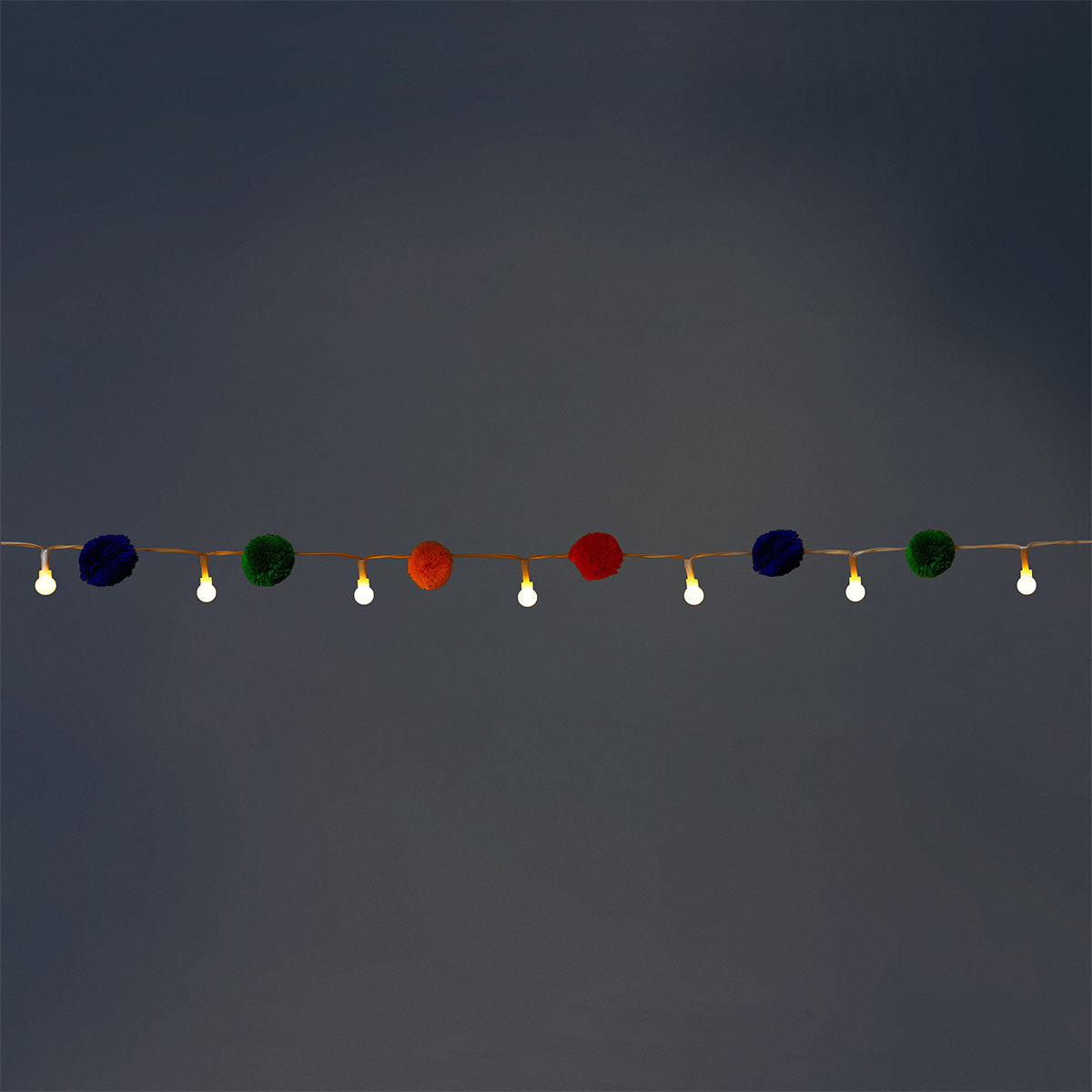 Colorful string lights with multi-colored pompoms, ideal for home decor by Flying Tiger Copenhagen.