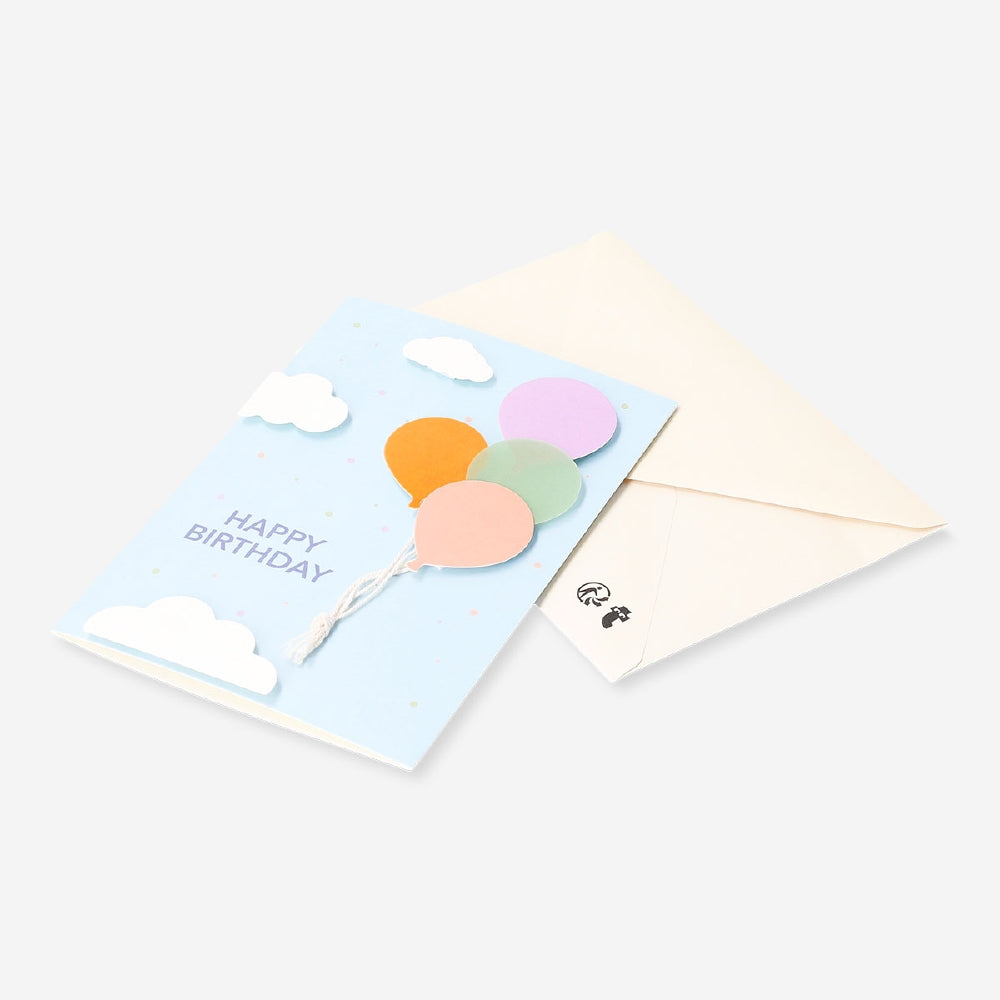 Office birthday card with colorful flying balloons design by Flying Tiger Copenhagen, featuring vibrant balloon illustrations.
