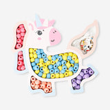 Wooden bead set with string featuring unicorn shapes, ideal for crafts and DIY projects by Flying Tiger Copenhagen