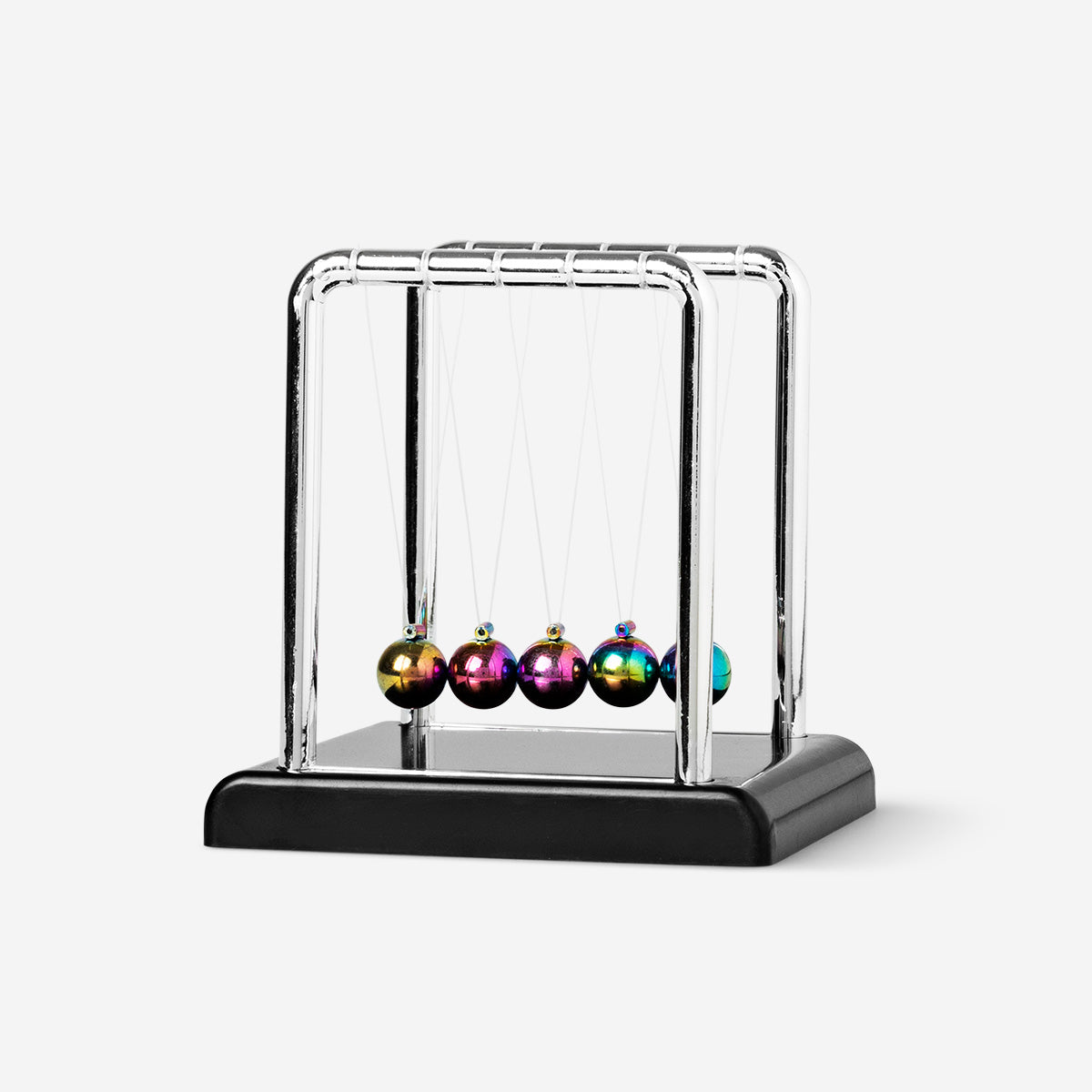 Small Newton's cradle gadget by Flying Tiger Copenhagen showing five metal balls swinging on strings.
