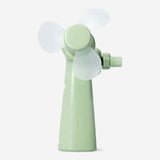 Green handheld fan gadget by Flying Tiger Copenhagen, compact and portable with a sleek design for personal cooling.
