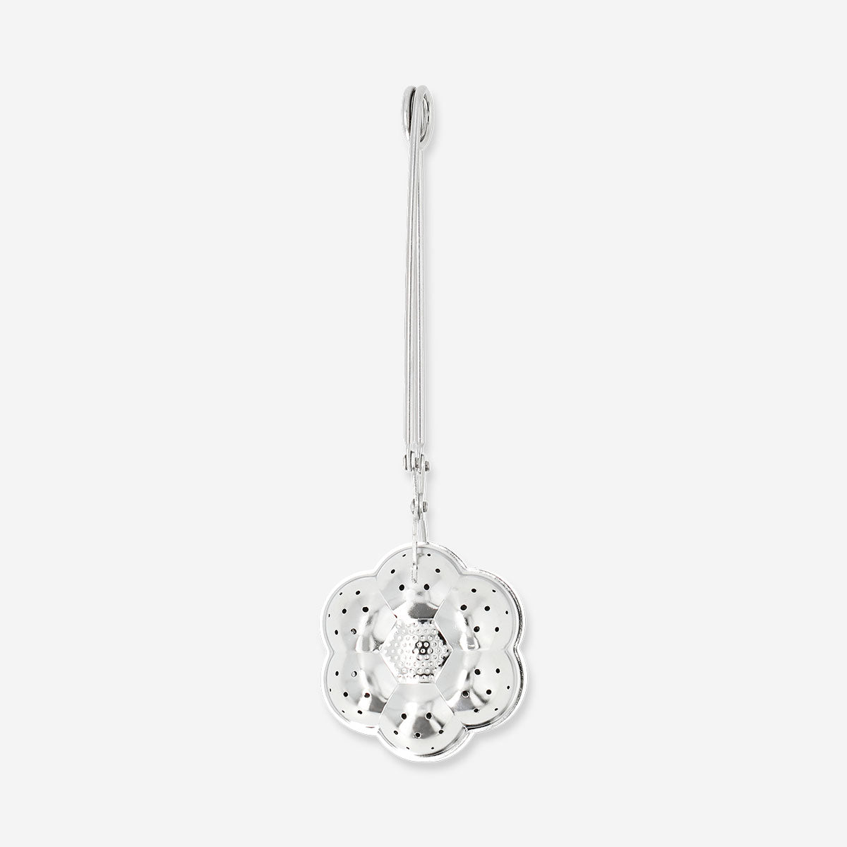 Flying Tiger Copenhagen flower tea infuser in kitchen, stainless steel mesh with flower-shaped design for brewing loose tea.