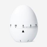 White kitchen egg timer by Flying Tiger Copenhagen, showing a round, minimalist design with dial and timer markings.