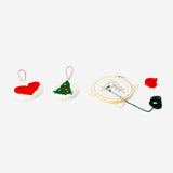 Christmas-themed punch needle set by Flying Tiger Copenhagen, featuring colorful yarn and tools for festive embroidery crafts.