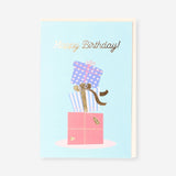 Office birthday card from Flying Tiger Copenhagen featuring stacked colorful presents with festive wrapping and ribbons.