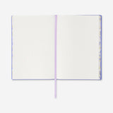 A5 lilac bullet planner with soft cover from Flying Tiger Copenhagen, open to show lined pages and compact office organizer design.