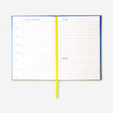 Blue A5 weekly office planner by Flying Tiger Copenhagen with visible weekly layout and colorful design.