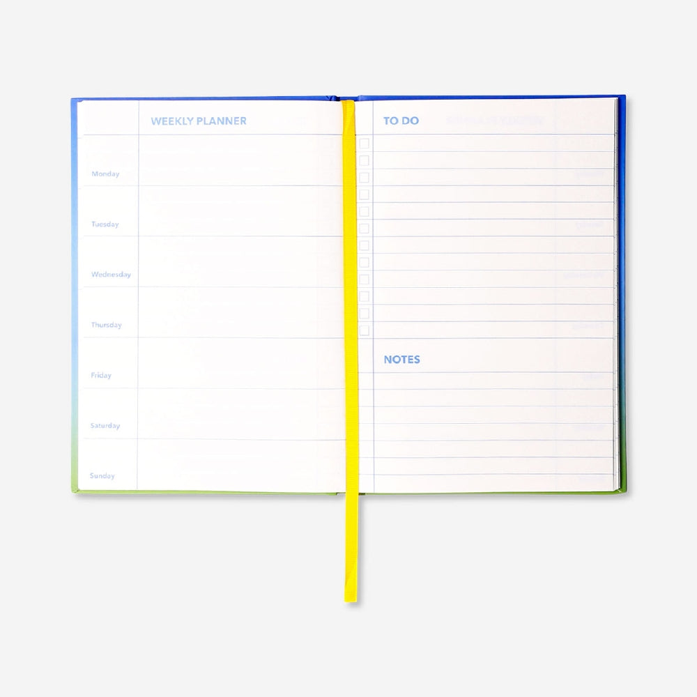 Blue A5 weekly office planner by Flying Tiger Copenhagen with visible weekly layout and colorful design.