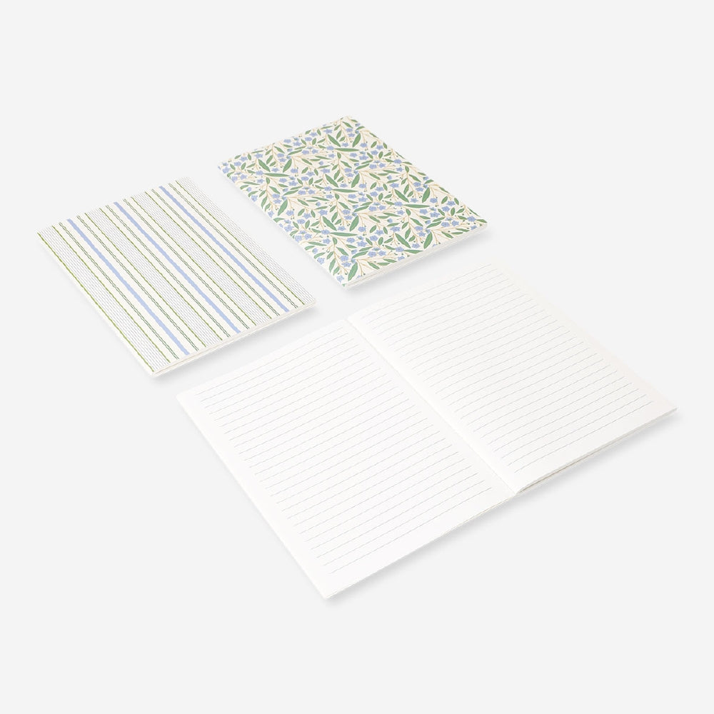 Set of three Flying Tiger Copenhagen A5 floral notebooks for office use, featuring colorful floral cover designs.