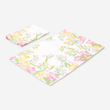 Two floral fabric napkins from Flying Tiger Copenhagen, featuring colorful flower patterns, suitable for home table settings.