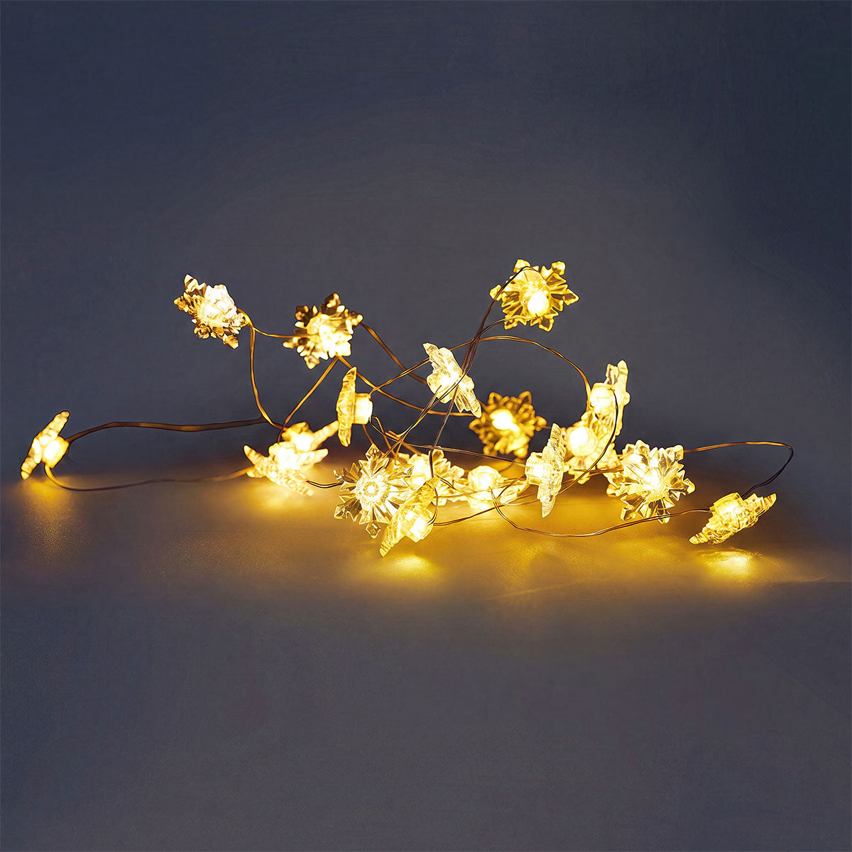 Flying Tiger Copenhagen snowflake string lights for home decor, featuring delicate snowflake-shaped LED lights for cozy ambiance.