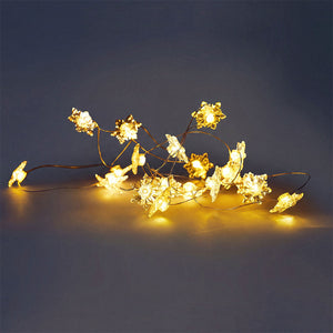 Flying Tiger Copenhagen snowflake string lights for home decor, featuring delicate snowflake-shaped LED lights for cozy ambiance.
